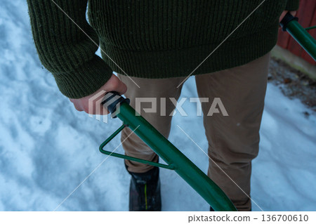 Winter Firewood Preparation by Rustic Wooden Cabin. 136700610