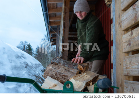Rural Winter Lifestyle and Firewood Preparation. 136700615
