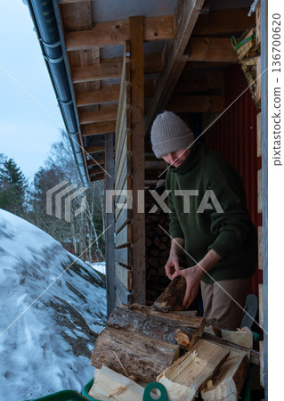 Rural Winter Lifestyle and Firewood Preparation. 136700620