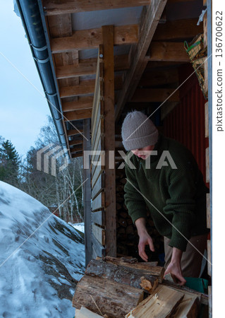 Rural Winter Lifestyle and Firewood Preparation. 136700622