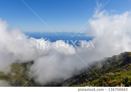 From a high viewpoint near Curral das Freiras, Madeira, white mist spills over ridges to Atlantic From a high viewpoint near Curral das Freiras, Madeira, white mist spills over ridges to Atlantic 136700665
