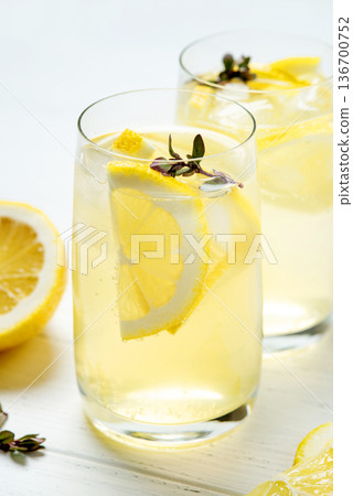 Homemade lemonade with lemon on a white background Homemade lemonade with lemon on a white background 136700752