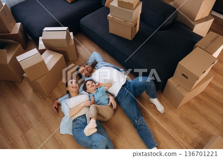 Lying down of floor, relaxing. Family of husband, wife and son are moving into new house Lying down of floor, relaxing. Family of husband, wife and son are moving into new house 136701221