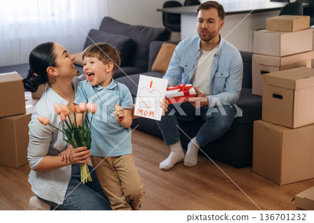 Mother have a birthday, gifts and flowers. Family of husband, wife and son are moving into new house 136701232