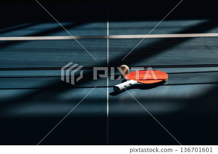 Racket and ball are on the tennis table indoors 136701601