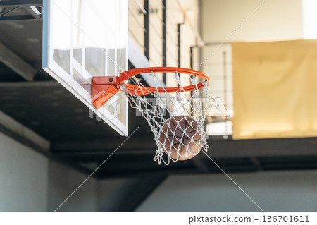 Basketball ball is in the hoop, photo in motion Basketball ball is in the hoop, photo in motion 136701611