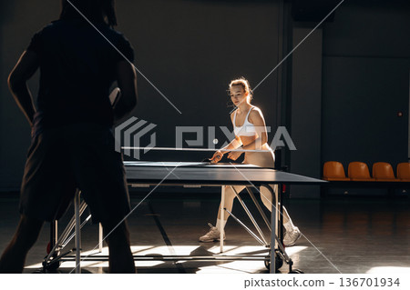 Tennis game, man and woman are indoors Tennis game, man and woman are indoors 136701934