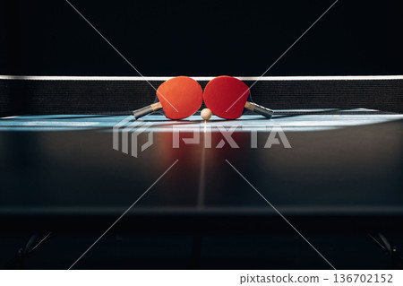 Horizontal photo. Two rackets and ball on the tennis table 136702152
