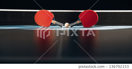 Horizontal photo. Two rackets and ball on the tennis table 136702153