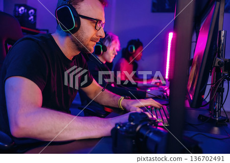 Session of online tournament. Gamers are playing video game by computers Session of online tournament. Gamers are playing video game by computers 136702491