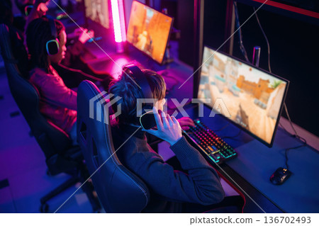 Shooter game. People are playing video game by computers Shooter game. People are playing video game by computers 136702493
