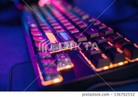 Colorful keyboard. Gaming computer is in the dark room with neon lighting 136702532