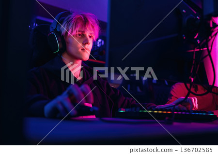 Gamers are playing video game by computers Gamers are playing video game by computers 136702585