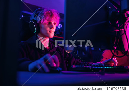 Session of online tournament. Gamers are playing video game by computers 136702586