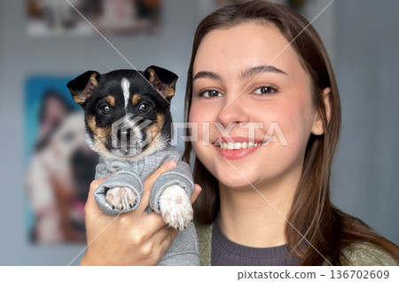Animal shelter volunteer takes care of dog. Dog at the shelter. 136702609