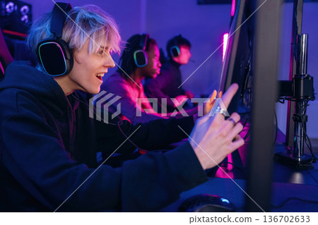 By high end PC. Gamers are playing video game by computers By high end PC. Gamers are playing video game by computers 136702633