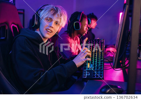 By high end PC. Gamers are playing video game by computers By high end PC. Gamers are playing video game by computers 136702634