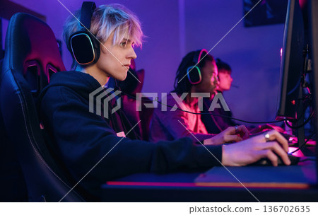 By high end PC. Gamers are playing video game by computers 136702635