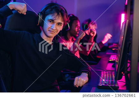 Team has won. Gamers are playing video game by computers Team has won. Gamers are playing video game by computers 136702661