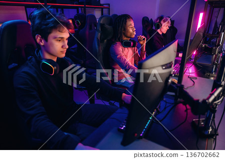 Session of online tournament. Gamers are playing video game by computers Session of online tournament. Gamers are playing video game by computers 136702662