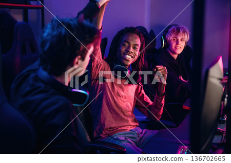 Team has won. Gamers are playing video game by computers 136702665