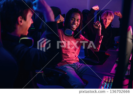 Team has won. Gamers are playing video game by computers Team has won. Gamers are playing video game by computers 136702666