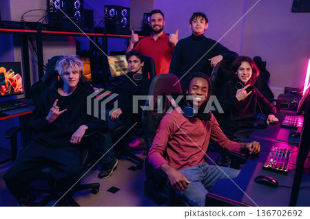 Team of gamers are chilling together indoors Team of gamers are chilling together indoors 136702692
