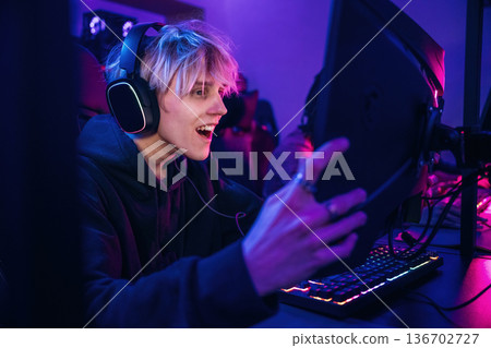 By high end PC. Gamers are playing video game by computers By high end PC. Gamers are playing video game by computers 136702727