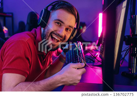 Smiling, positive facial expression. Gamers are playing video game by computers 136702775