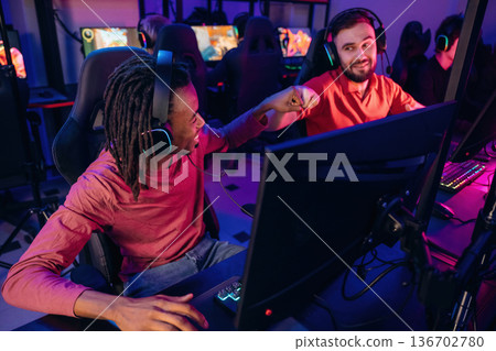 Victory, nice job, hands gestures. Gamers are playing video game by computers Victory, nice job, hands gestures. Gamers are playing video game by computers 136702780