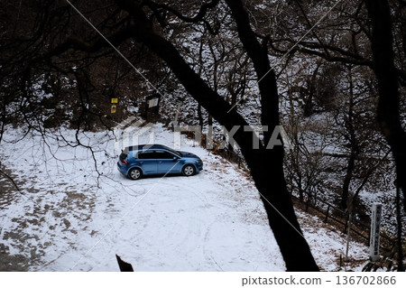 Blue car parked in the snow Blue car parked in the snow 136702866