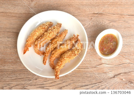 crispy fried shrimp coating flake bread and flour or tempura Japanese food on plate dipping spicy and sour seafood chili sauce 136703046