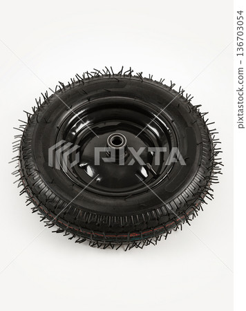 Wheel is pneumatic on a white background. Black rubber and disc. 136703054