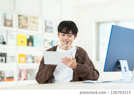 Young male engineer working in the office Young male engineer working in the office 136703215