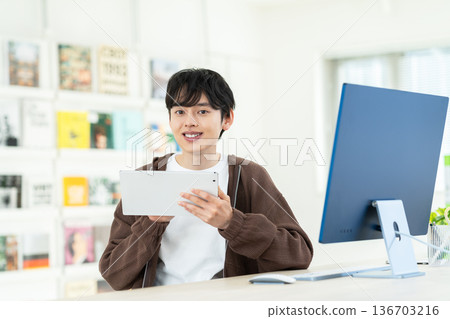Young male engineer working in the office Young male engineer working in the office 136703216