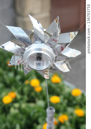 A handmade windmill made from recycled aluminum cans at the entrance A handmade windmill made from recycled aluminum cans at the entrance 136703758
