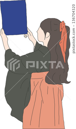 A woman in a hakama holding up her diploma A woman in a hakama holding up her diploma 136704320