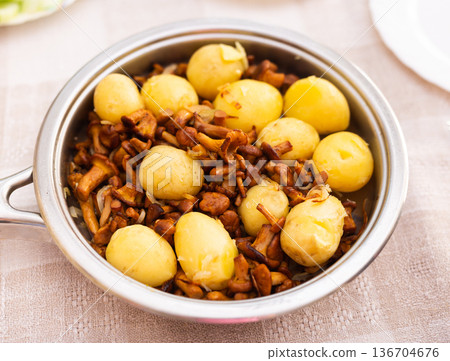 fried chanterelles with new potatoes in a frying pan 136704676