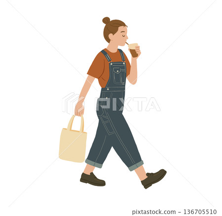 A woman walks with a coffee and a handbag in her hand. A woman walks with a coffee and a handbag in her hand. 136705510