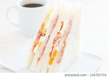 A delicious bacon, egg, lettuce, and tomato sandwich with coffee for breakfast A delicious bacon, egg, lettuce, and tomato sandwich with coffee for breakfast 136705758