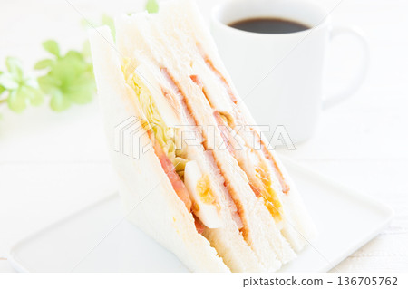 A delicious bacon, egg, lettuce, and tomato sandwich with coffee for breakfast A delicious bacon, egg, lettuce, and tomato sandwich with coffee for breakfast 136705762