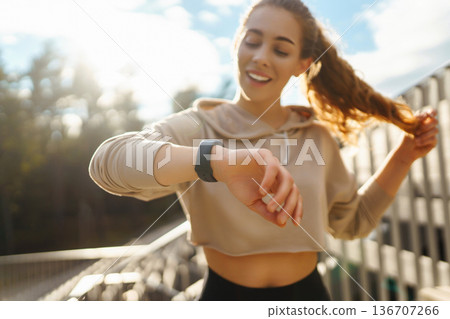 Beautiful woman outdoors and sportswear doing fitness. Concept of sport, recreation. Beautiful woman outdoors and sportswear doing fitness. Concept of sport, recreation. 136707266
