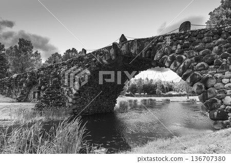 Black and white photo featuring historic stone bridge 136707380