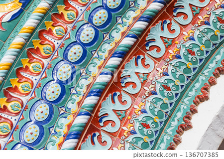 Ornate colorful ceramic tiles. Decoration of old arch 136707385