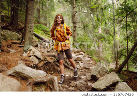 Young woman with backpack traveling outdoors. Hiking, active lifestyle. Young woman with backpack traveling outdoors. Hiking, active lifestyle. 136707426