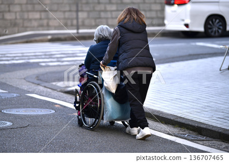 Yokohama cityscape in Japan: Steps and unevenness... Aging society: Elderly woman in wheelchair (no markings) has a hard time pushing... = Yokohama city 136707465