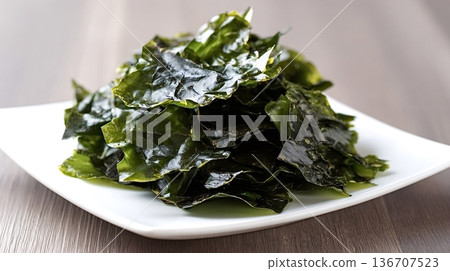 Dried seaweed snacks on white plate healthy savory food Dried seaweed snacks on white plate healthy savory food 136707523
