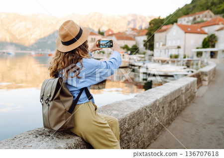 Female tourist taking images of city during leisure time for creating publication in blog. Lifestyle Female tourist taking images of city during leisure time for creating publication in blog. Lifestyle 136707618