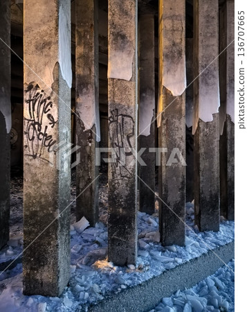 Concrete pillars reinforcing the promenade's coastline are covered in graffiti 136707665