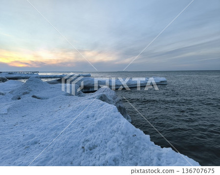 Snow and ice buildup on breakwaters in the Baltic Sea in winter Snow and ice buildup on breakwaters in the Baltic Sea in winter 136707675